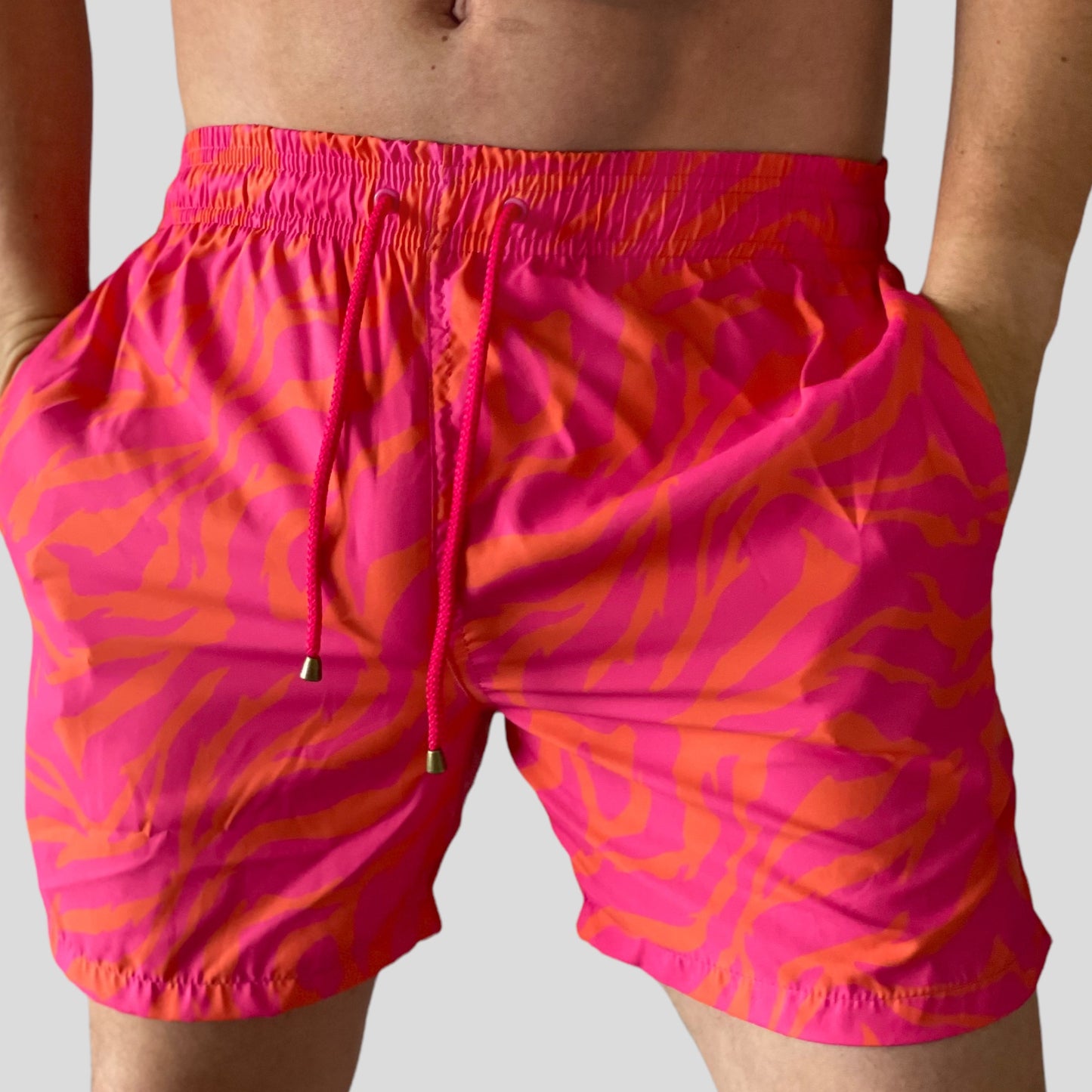 Pantaloneta de baño con diseño animal print naranja y fucsia